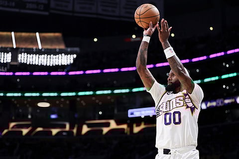 Phoenix Suns forward Royce O'Neale prepares to shoot against the Los Angeles Lakers during the first half of an NBA basketball game  in Los Angeles.
