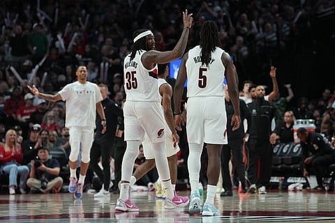 Portland Trail Blazers center/forward Robert Williams III (35) reacts after making a 3-pointer during the first half of an NBA basketball game against the Los Angeles Clippers in Portland, Ore.