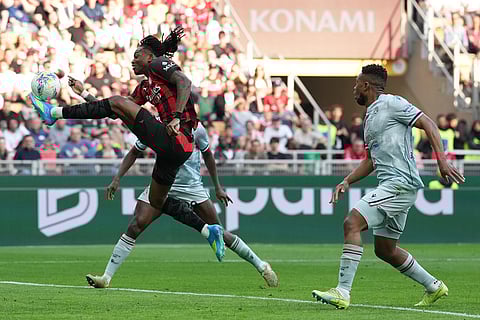 AC Milan's Rafael Leao shoots during the Serie A soccer match between AC Milan and Udinese, in Milan, Italy.