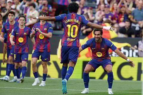 Barcelona's Ferran Torres, right, celebrates after scoring the opening goal with Barcelona's Lamine Yamal, centre back to the camera, during the Spanish La Liga soccer match between Barcelona and Espanyol in Barcelona, Spain.