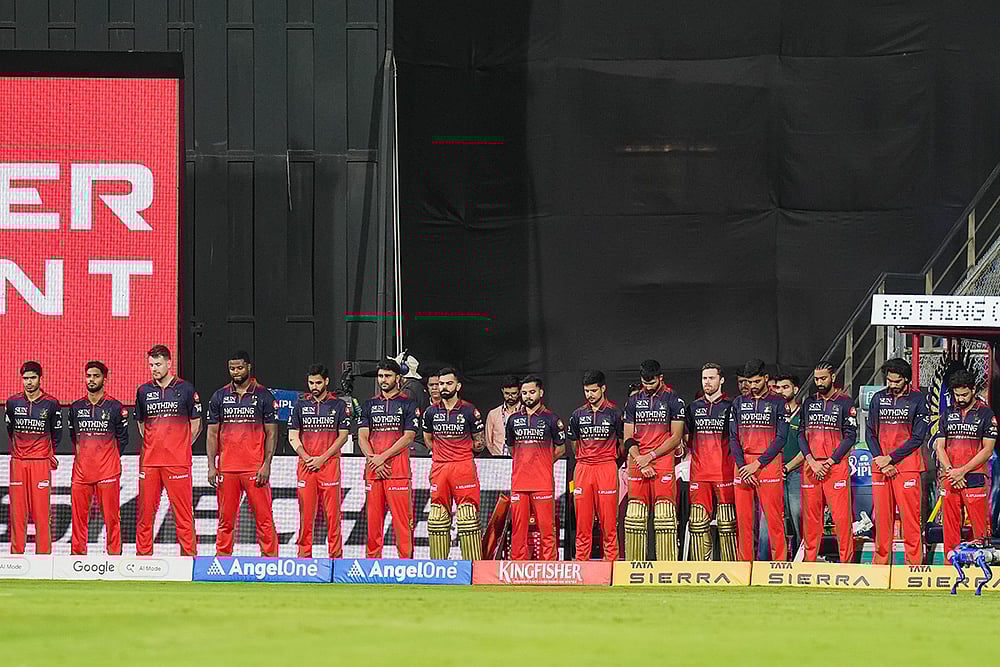 Players of Royal Challengers Bengaluru observe a moment of silence in memoriam of singing legend Asha Bhosle, before an Indian Premier League (IPL) 2026 T20 cricket match between Mumbai Indians and Royal Challengers Bengaluru, in Mumbai, Maharashtra. Bhosle, India's beloved singing icon, died at the age of 92 on Sunday following multiple organ failure, doctors treating her said. - | Photo: PTI/Kunal Patil