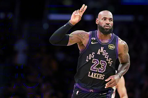 Los Angeles Lakers forward LeBron James gestures after making a basket against the Phoenix Suns during the first half of an NBA basketball game in Los Angeles.