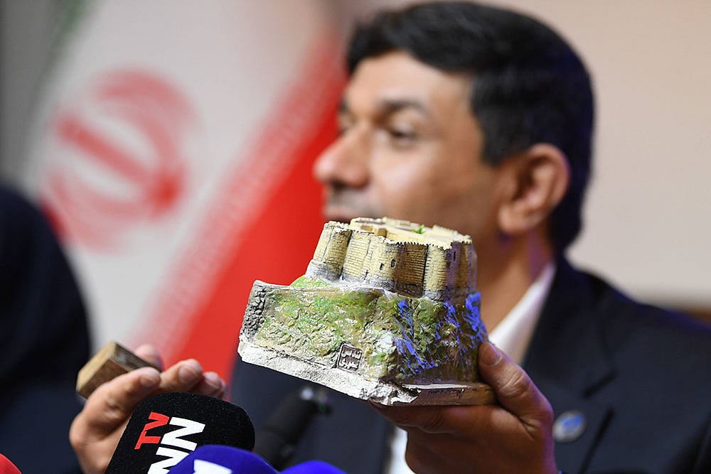 Hassan Fartousi, secretary-general of the Iranian National Commission for UNESCO displays a miniature of Falak-ol-Aflak Castle, which is damaged by U.S. and Israeli airstrikes during a press conference in Tehran, Iran.