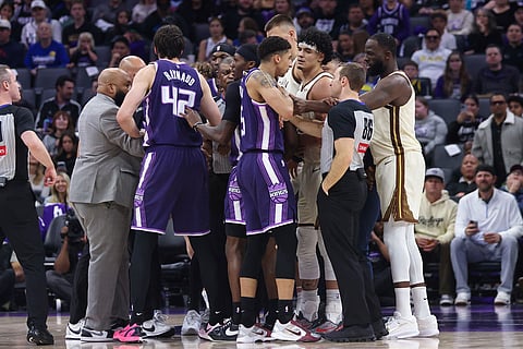 Members of the Sacramento Kings and Golden State Warriors finish pushing and shoving after a foul on Sacramento Kings center Maxime Raynaud (42) during the second half of an NBA basketball in Sacramento, Calif.