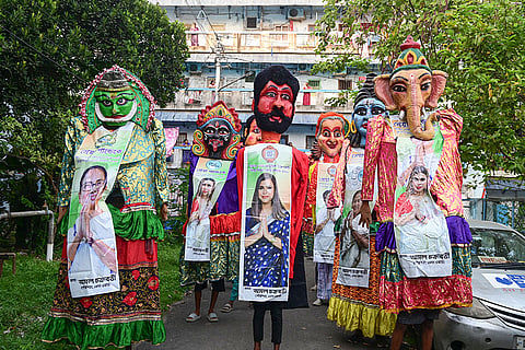 TMC supporters gather during a roadshow in support of the party candidate from Maniktala constituency,  Shrreya Pande ahead of the West Bengal Assembly elections, in Kolkata.