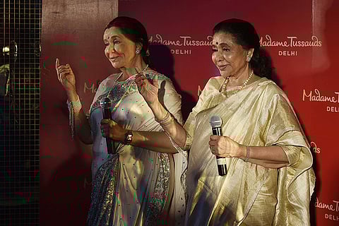 Legendary singer Asha Bhosle during an unveiling of her wax figure at the Madame Tussauds museum in New Delhi, India.