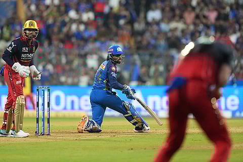 Mumbai Indians' Tilak Verma reacts after loosing his wicket during the Indian Premier League cricket match between Mumbai Indians and Royal Challengers Bengaluru, in Mumbai, India.