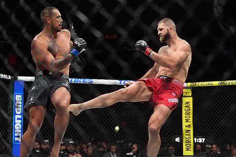 Carlos Ulberg, left, of New Zealand, fights with Jiri Prochazka, of Czechia, in their light heavyweight title bout at a UFC 327 mixed martial arts event in Miami.