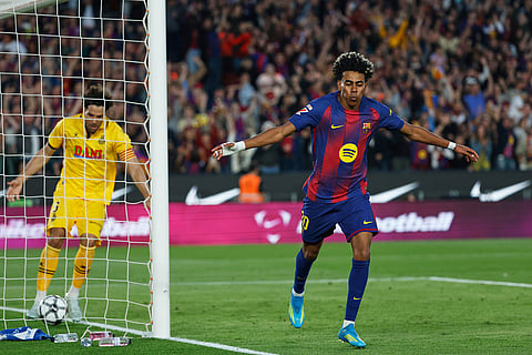Barcelona's Lamine Yamal, right, celebrates after scoring his side's third goal during the Spanish La Liga soccer match between Barcelona and Espanyol in Barcelona, Spain.