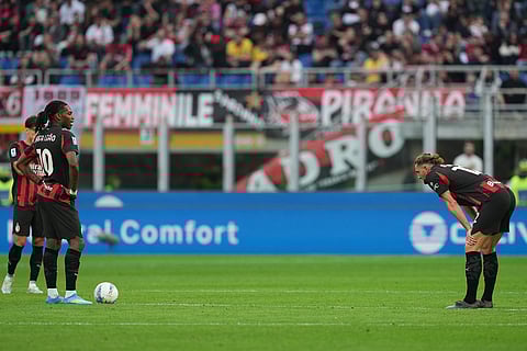 AC Milan players stand dejected after conceiding a goal during the Serie A soccer match between AC Milan and Udinese, in Milan, Italy.