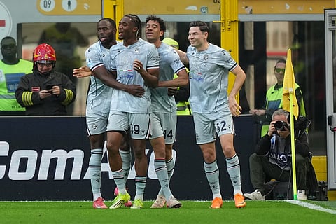 Udinese players celebrate after scoring during the Serie A soccer match between AC Milan and Udinese, in Milan, Italy.