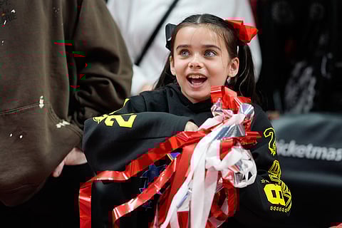 A fan picks up streamers after the Portland Trail Blazers won an NBA basketball game against the Los Angeles Clippers in Portland, Ore.