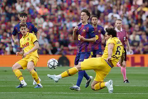 Barcelona's Gavi, centre, and Espanyol's Leandro Cabrera, right, challenge for the ball during the Spanish La Liga soccer match between Barcelona and Espanyol in Barcelona, Spain.