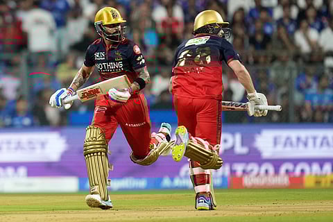 Royal Challengers Bengaluru's Virat Kohli, left and Phil Salt run between the wickets to score during the Indian Premier League cricket match between Mumbai Indians and Royal Challengers Bengaluru, in Mumbai , India.