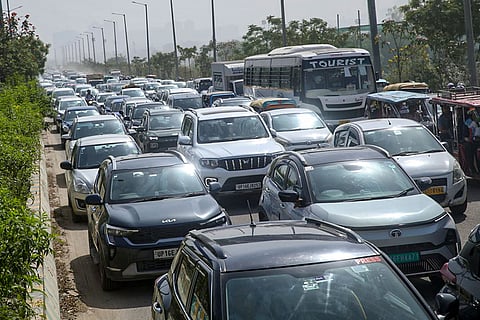 Vehicles are stuck in a traffic jam as factory workers stage a protest demanding a hike in wages, in Noida, Gautam Buddh Nagar district, Uttar Pradesh. The protest carried incidents of arson, vandalism and stone-pelting reported from Phase-2 and Sector 60 areas, police said.