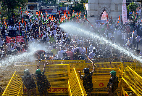 Police use water cannons to disperse Indian Youth Congress members during a protest against the US trade deal, in Jabalpur.