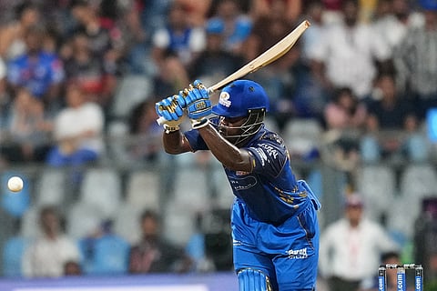 Mumbai Indians' Shefane Rutherford hits a boundary during the Indian Premier League cricket match between Mumbai Indians and Royal Challengers Bengaluru, in Mumbai , India.