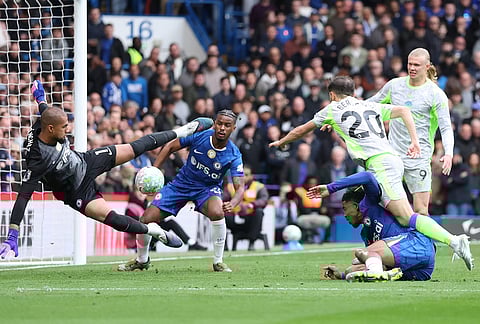 Chelsea's goalkeeper Robert Sanchez saves in front pf Manchester City’s Bernardo Silva during the Premier League soccer match between Chelsea and Manchester City in London.