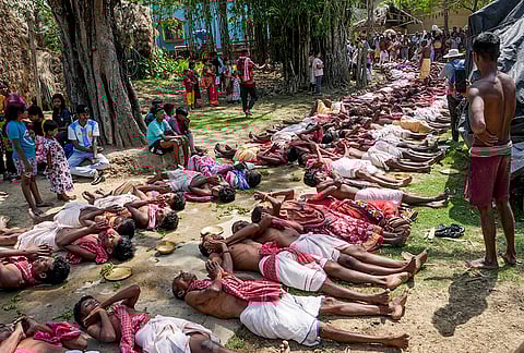 Sannyasis perform rituals during the Gajan festival at Sonapalashi Buro Shiv Tala, in Purba Bardhaman district, West Bengal. The festival, dedicated to Lord Shiva and observed on the last day of the Bengali year, involves devotees performing rigorous penance and traditional rituals. 