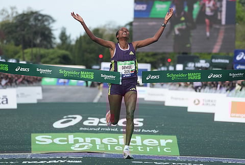 Ethiopia's Shure Demise crosses the finish line to win the women's race of the Paris marathon, in Paris.