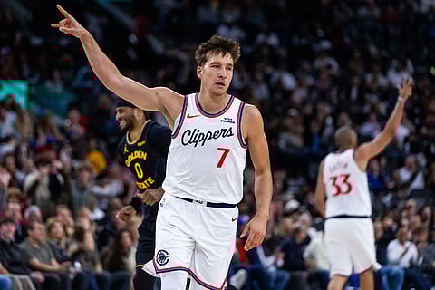 Los Angeles Clippers guard Bogdan Bogdanovic (7) gestures after scoring against the Golden State Warriors during the second half of an NBA basketball game in Inglewood, Calif.