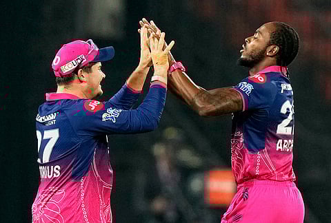 Rajasthan Royals' Jofra Archer, right, celebrates with Lhuan-dre Pretorius the wicket of Sunrisers Hyderabad's Abhishek Sharma during the Indian Premier League cricket match between Sunrisers Hyderabad and Rajasthan Royals in Hyderabad.