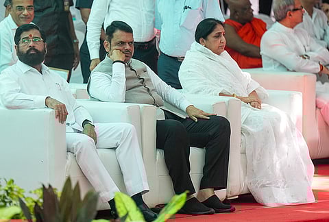 Maharashtra Chief Minister Devendra Fadnavis, centre, along with Deputy Chief Ministers Eknath Shinde, left, and Sunetra Pawar during the last rites of singer Asha Bhosle at a crematorium, in Mumbai.