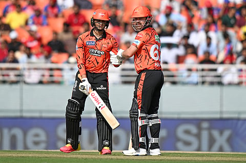 Sunrisers Hyderabad's Abhishek Sharma, left, and batting partner Travis Head celebrate scoring runs during the Indian Premier League cricket match between Punjab Kings and Sunrisers Hyderabad in New Chandigarh, India, Saturday, April 11, 2026