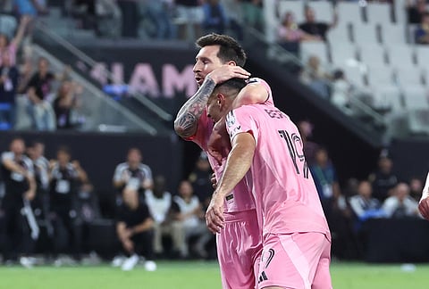 Inter Miami forward Lionel Messi, top, celebrates after a goal by forward Germán Berterame (19) in the second half of an MLS soccer match against the New York Red Bulls, in Miami.