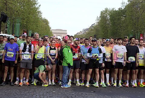 Competitors prepare to run the men's race of the Paris marathon, in Paris.