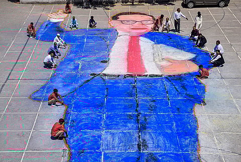 People create a portrait of BR Ambedkar on the eve of his birth anniversary, in Moradabad.