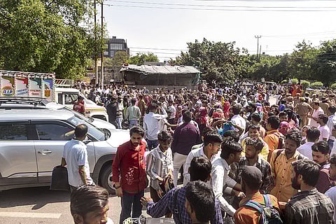 People stage a protest demanding a salary hike at Phase 2 Hosiery Complex, in Noida.