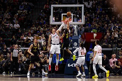 Golden State Warriors guard De'anthony Melton (8) goes to the basket against Los Angeles Clippers center Brook Lopez (11) during the first half of an NBA basketball game in Inglewood, Calif.