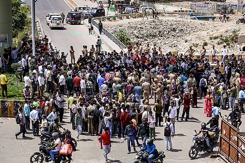 Garment company workers at the Hosiery Complex block the road as they stage a protest demanding a hike in their salary and other various issues, at Noida, in Gautam Buddh Nagar district, Uttar Pradesh.