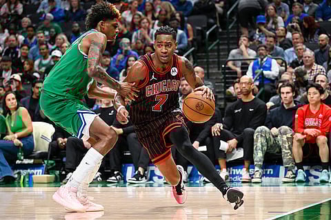 Chicago Bulls' Rob Dillingham drives against Dallas Mavericks' AJ Johnson during an NBA basketball game in Dallas.