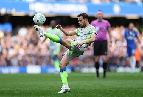 Manchester City's Bernardo Silva clears the ball during the Premier League soccer match between Chelsea and Manchester City in London.