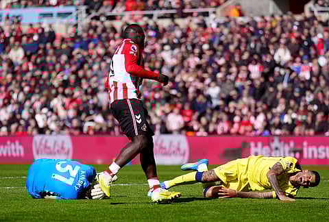 Sunderland's Brian Brobbey, centre, looks on after pushing Tottenham Hotspur's Cristian Romero, right, into Tottenham Hotspur goalkeeper Antonin Kinsky, left, during the Premier League soccer match between Sunderland and Tottenham Hotspur, in Sunderland, England.