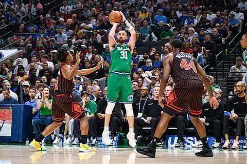 Dallas Mavericks' Klay Thompson shoots over Chicago Bulls' Collin Sexton during an NBA basketball game in Dallas.