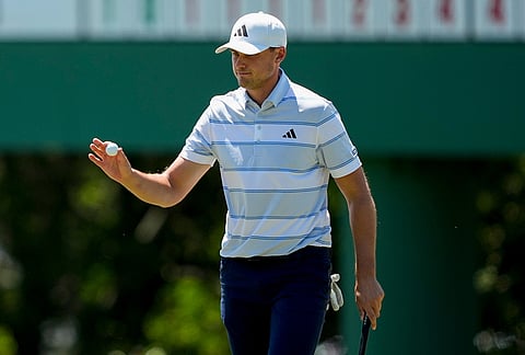 Ludvig Aberg, of Sweden, waves after his putt on the third hole during the final round of the Masters golf tournament at the Augusta National Golf Club in Augusta, Georgia. 