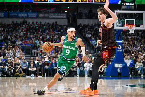 Dallas Mavericks' Ryan Nembhard drives against Chicago Bulls' Lachlan Olbrich during an NBA basketball game in Dallas.