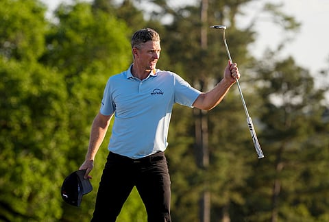 Justin Rose, of England, waves after his putt on the 18th hole during the third round of the Masters golf tournament at the Augusta National Golf Club, in Augusta, Georgia.