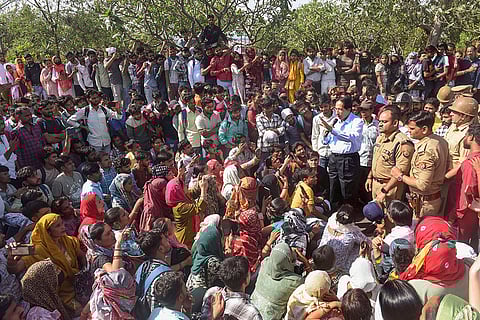 People stage a protest demanding a salary hike at Phase 2 Hosiery Complex, in Noida.