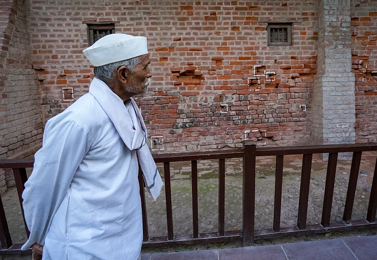 An eldery man looks at the bullet marks on a wall during a visit to the Jallianwala Bagh Martyrs' Memorial on the eve of its massacre anniversary, in Amritsar, Sunday, April 12, 2026. The memorial at this site commemorates the unarmed Indians who were wounded or shot indiscriminately by the British troops on April 13, 1919 while participating in a peaceful public meeting, during the India's freedom struggle. - PTI