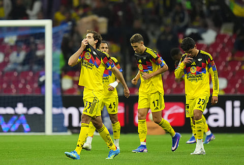 America's Patricio Salas, left, celebrates scoring his side's opening goal against Cruz Azul during a Mexican soccer league match in Mexico City.