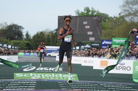 Italy's Yemaneberhan Crippa crosses the finish line to win the men's race of the Paris marathon, in Paris.