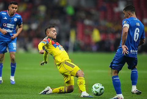 Cruz Azul's Erik Lira, right, and America's Erick Sanchez vie for the ball during a Mexican soccer league match in Mexico City.