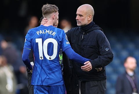 Manchester City's head coach Pep Guardiola hugs Chelsea's Cole Palmer after the Premier League soccer match between Chelsea and Manchester City in London.