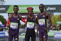 Paris Marathon 2026: Yemaneberhan Crippa Makes History While Shure Demise Smashes Course Record | Photo: AP/Thibault Camus : From left, Ethiopia's Bayelign Teshager, Italy's Yemaneberhan Crippa and Kenya's Sila Kiptoo pose after crossing the finish line of the men's race of the Paris marathon, in Paris.