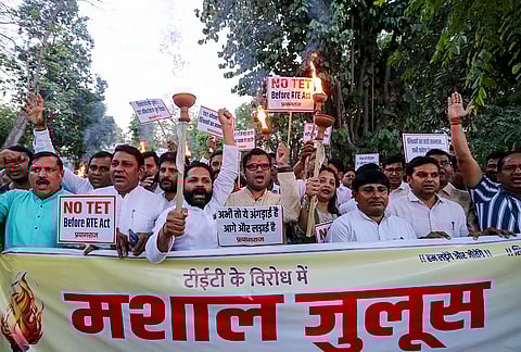 Akhil Bhartiya Rashtriya Shaikshik Mahasangh members raise slogans during a protest march against the Supreme Court judgment, which ruled that all in-service teachers who have not passed the Teacher Eligibility Test (TET) will have to qualify within two years to continue in service, in Prayagraj.