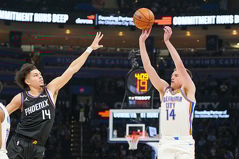 Oklahoma City Thunder forward Payton Sandfort, right, shoots over Phoenix Suns guard Koby Brea during the second half of an NBA basketball game in Oklahoma City.